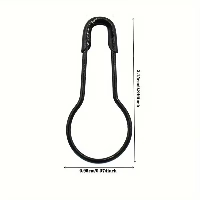 Black metal safety pin with measurements on a white background